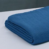Hospital blanket PerVal® Herringbone folded on hospital bed | Healthcare Blankets & Spreads