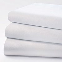 This stack of white sheets are our patented UniVal® sheets and pillowcases. They have a special finish designed to retain a crisp, clean appearance. Additionally, the high cotton content helps prevent staining and ensures whiteness is prolonged.