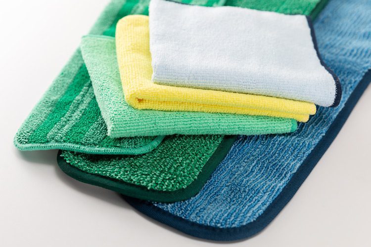 A stack of various size and color microfiber cleaning cloths.
