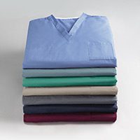 A stack of medical scrubs is shown here. This stack of hospital scrub tops shows many of the colors available in this unisex scrubs style.