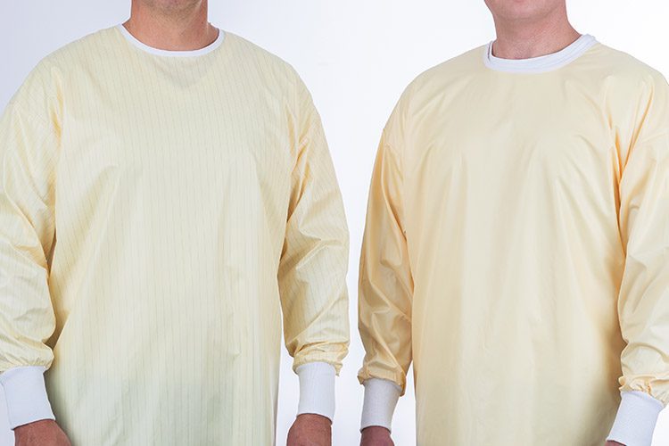 Two people wearing reusable isolation gowns. This reusable isolation gown is lightweight, latex free, and virtually lint free.