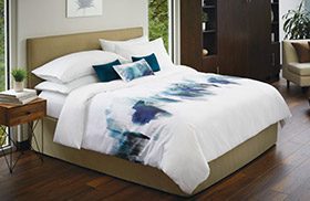 Modern hotel bed with graphic spread