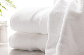 stack of white towels in hotel room
