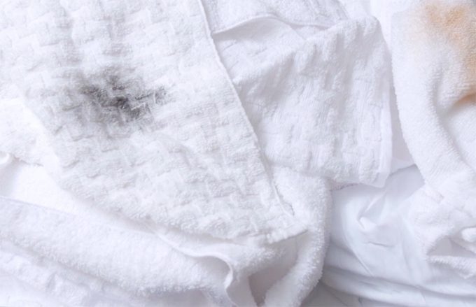 dark cosmetic stain on a white towel