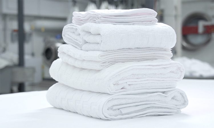 Stack of white hotel towels on a table
