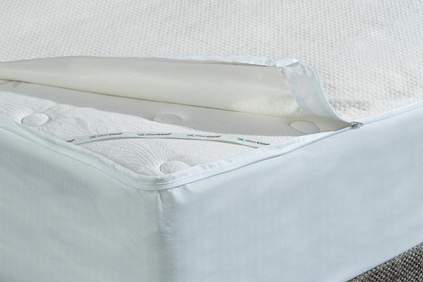 Corner of a bed covered by allerease mattress protector