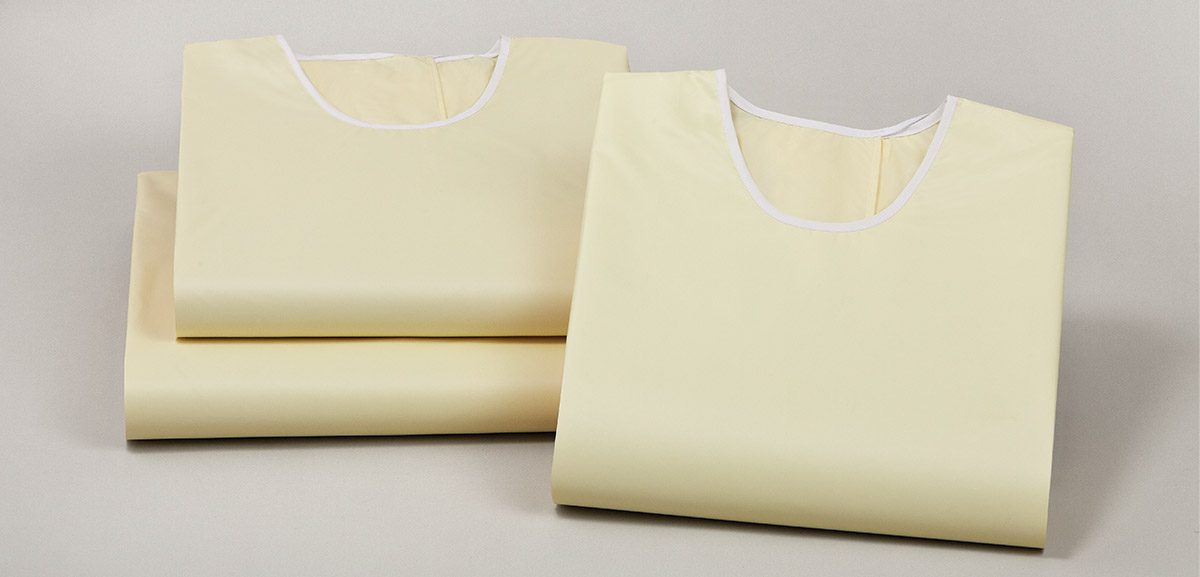 Stack of three Compel Isolation Gowns from Standard Textile