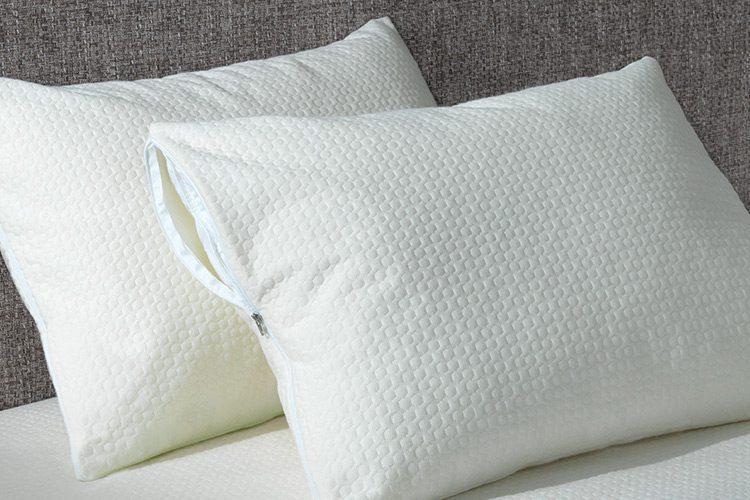 AllerEase Pillow Protectors against a headboard