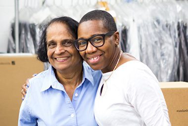 Two female Standard Textile associates smiling.