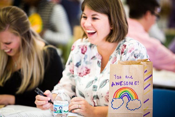 A candid moment showing two Standard Textile employees, smiling and laughing as they take part in a charity event.