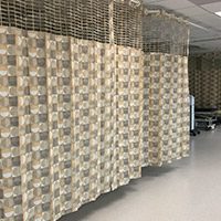 Disposable privacy curtains hanging in an emergency room.
