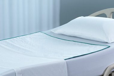 Hospital bed with DermaTherapy® sheets and underpad.