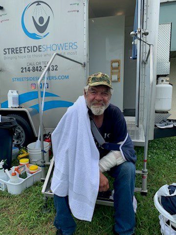 Man sitting in front of Streetside Mobile Showers