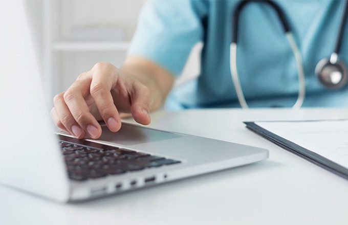 medical worker at laptop