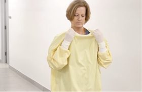 Person demonstrating how easy it is to remove an Easy Release gown. This image is a link to a video.