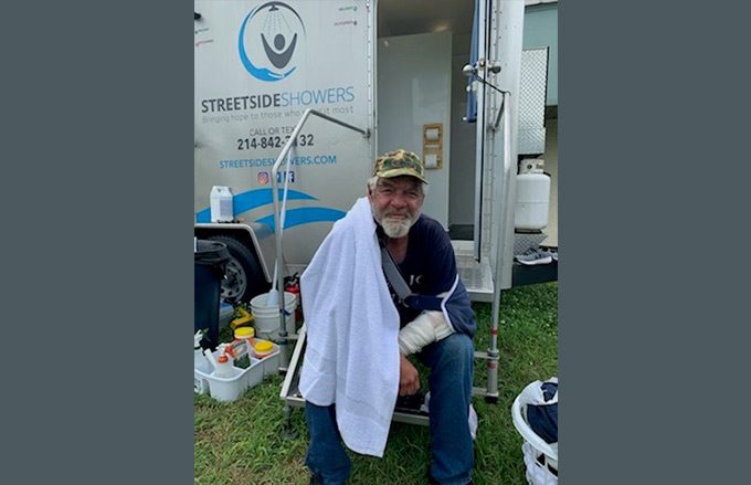 Streetside mobile shower unit with person