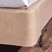 A basket weave box spring cover in a tan color