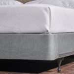 Encircle™ in Magnesium installed on a hotel bed box spring