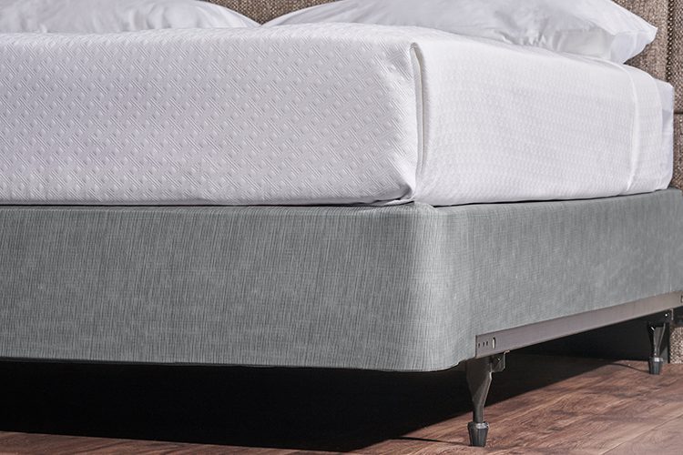 Encircle™ in Magnesium installed on a hotel bed box spring
