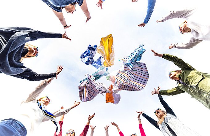 Group of people throwing hotel pool towels for wholesale in the air