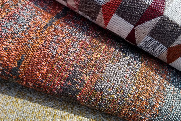 This is a detail image of a variety of high-performance and stylishly designed upholstery fabrics in eye-catching colors and patterns. Beyond beautiful these fabrics, are fabricated to be durable and tough.