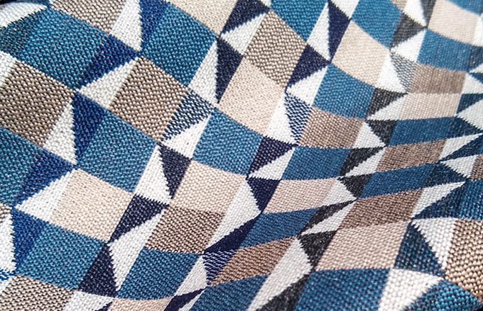 Fabric Zion in Bluestone is a square and triangle pattern in Cream, Blues and Beiges.