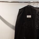 VersaValet garment bag with clean clothing hanging in a hotel closet
