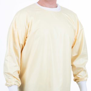 Image of a man wearing a yellow reusable surgical gown.
