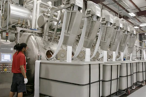 Image of associate observing the textiles being processed in Union, SC. It is a great place to work if you're looking for jobs in Union SC hiring.