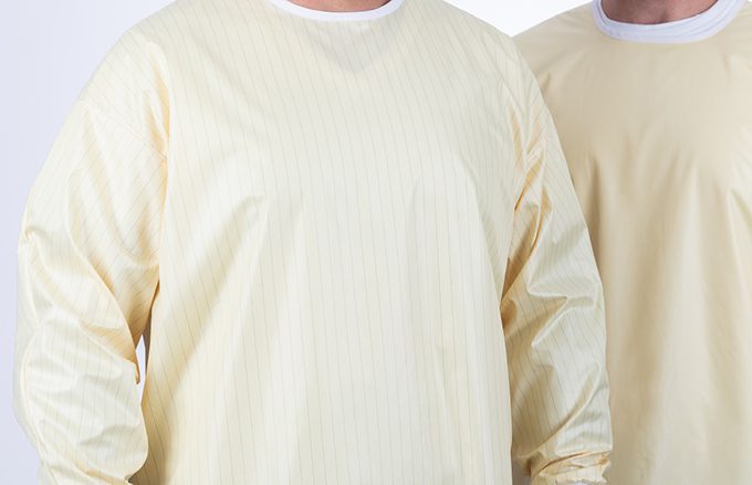 Two men wearing reusable isolation gowns.