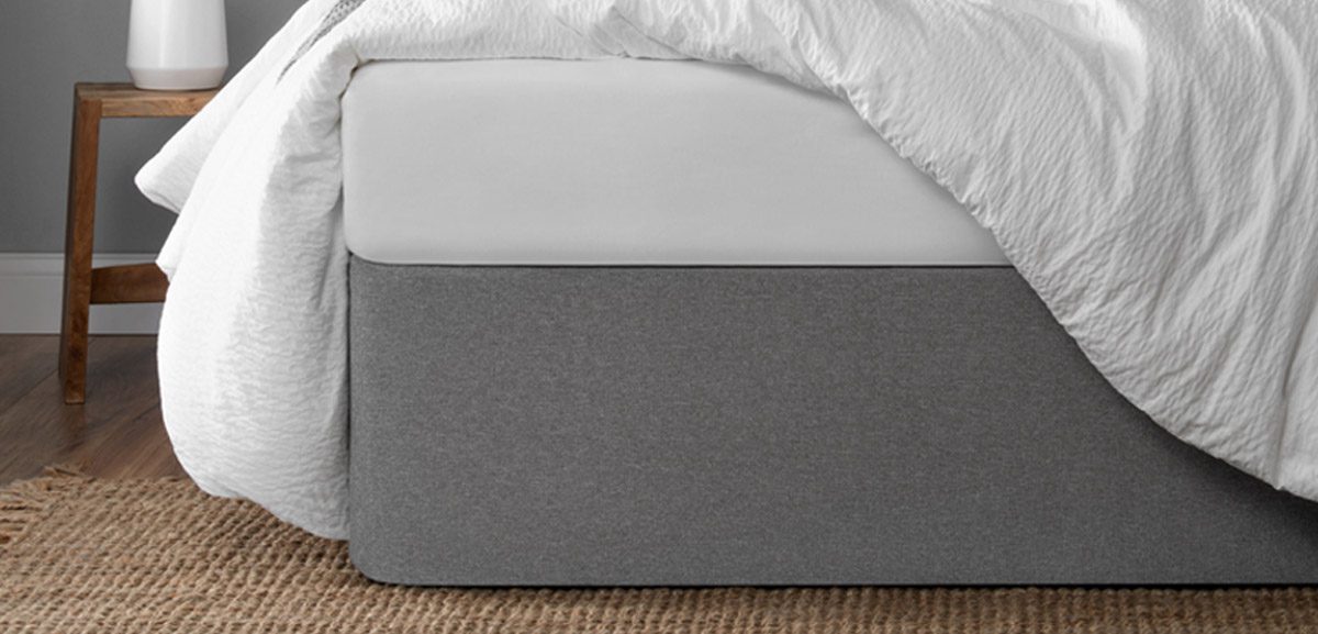 Close-up image of gray Circa Bed Wrap, a bed skirt and platform bed alternative