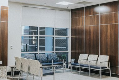 Image is of a waiting area with chairs in pretty patterns.