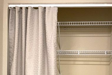 Fabric is being used to close off a closet storage area.