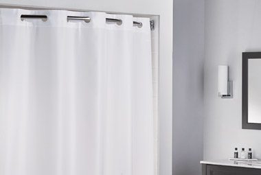 This image shows a white shower curtain with gromets.