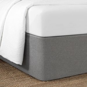 Corner of a bed featuring the Circa Bed Wrap Ready-to-Ship Fabric in Graphite.