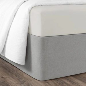 Corner of a bed featuring the Circa Bed Wrap Ready-to-Ship Fabric in Haze.
