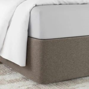 Corner of a bed featuring the Circa Bed Wrap Ready-to-Ship Fabric in Smokey Quartz.