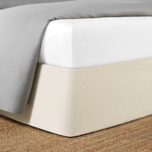 Corner of a bed featuring the Circa Bed Wrap Ready-to-Ship Fabric in Ivory.