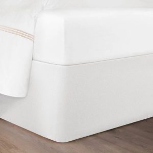 Corner of a bed featuring the Circa Bed Wrap Ready-to-Ship Fabric in White.