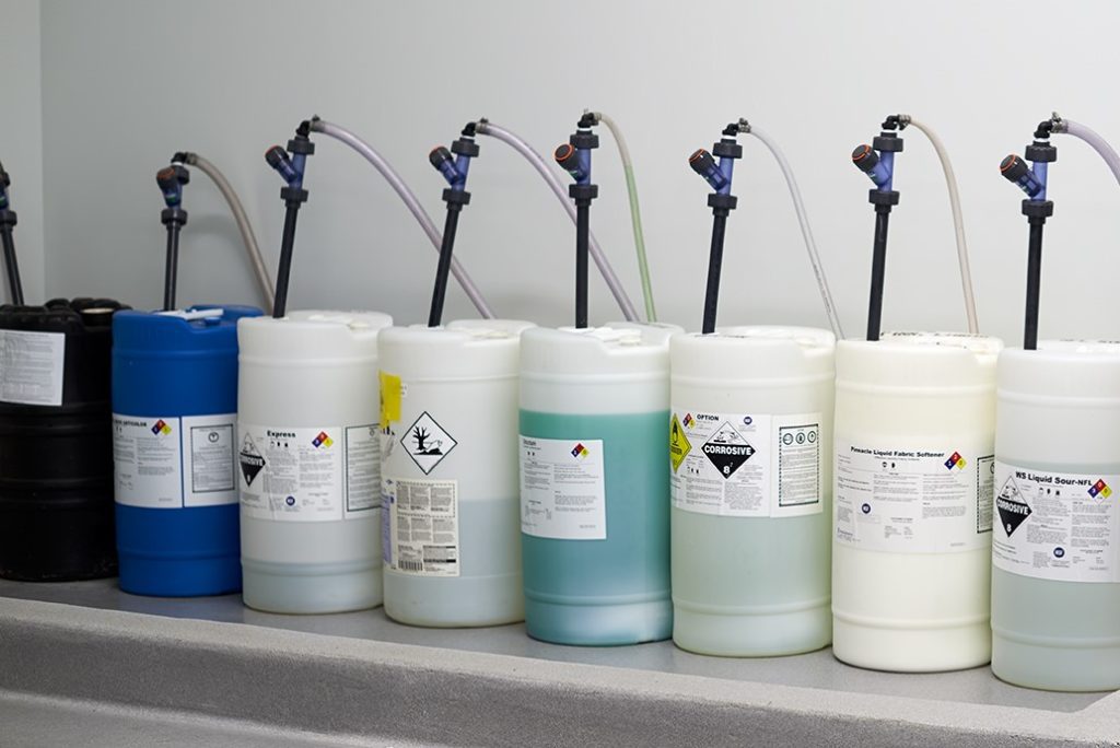 A row of hotel laundry chemicals