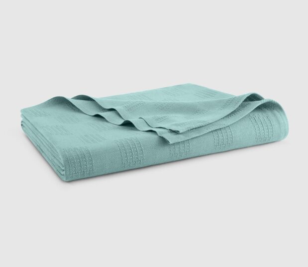 The Elite hospital blanket in Emerald is shown here folded.