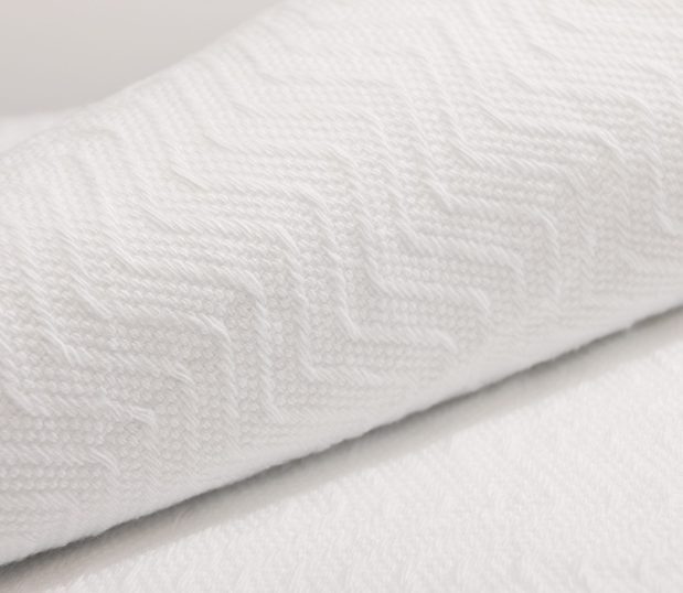 A detail of the textural herringbone blanket. These blankets are known to be breathable blankets.