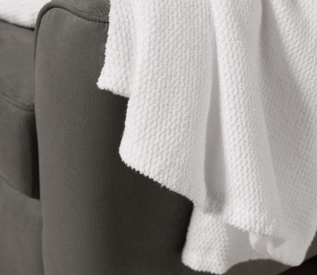 Detiail of a white Lynova all season blanket draped over a chair.