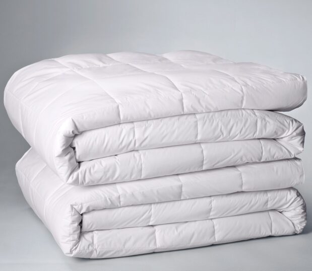 This is a stack of 2 folded all seasons duvet inserts.