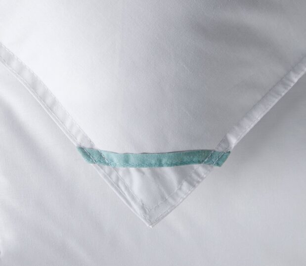 A detail of the corner of the white summer duvet.