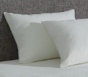 Two AllerEase pillows on a bed. These waterproof pillows feature a temperature balancing top layer.
