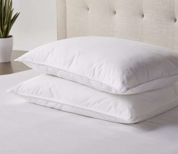 Image of White Chamber Firm on a bed. These pillows are a down alternative pillow.