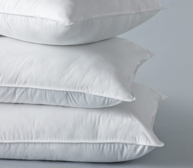 A Stack of Chamber pillows featuring a down alternative pillow filling.