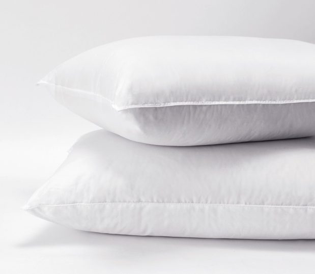 Stack of two polyester pillows. The Express pillow is a wholesale pillow that the budget-minded property will appreciate.