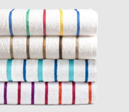 A stack of our four uniquely designed premium stripe pool towels.